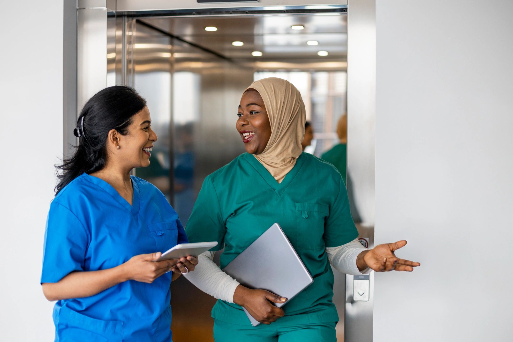 Medical professionals discussing work in a hospital corridor